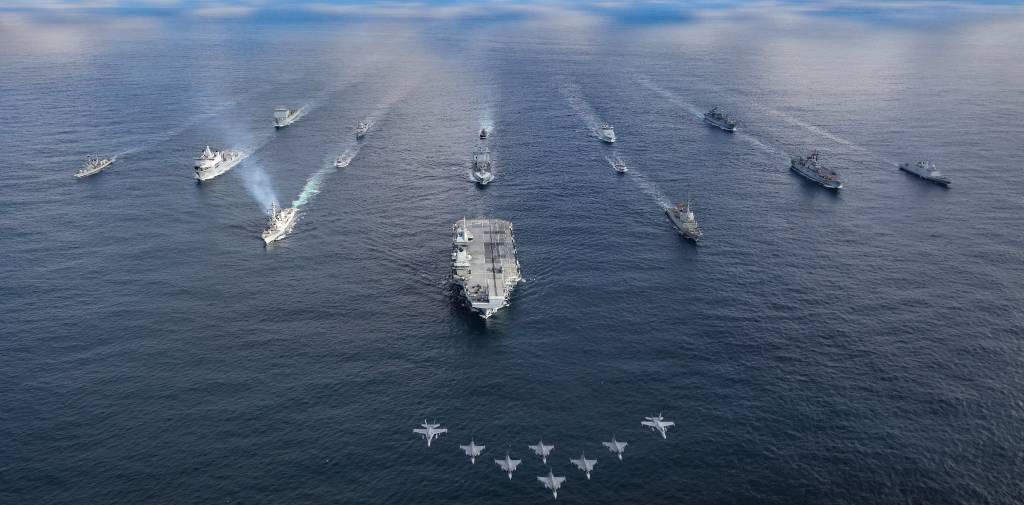 UK CARRIER TASK GROUP MEETS WITH NATO AMPHIBIOUS TASK GROUP

Pictured: HMS Prince of Wales leads the fifteen ship formation as jets fly past.

The UK-led Carrier Strike Group amalgamates with the NATO Amphibious Task Group and additional Norwegian naval units for a PHOTEX 13 Mar 24. Aircraft participating in the flypast were six Finnish F18 and two Swedish JAS-39. Fifteen ships sailed in formation as follows:

Front row: HMS Prince of Wales
Row 2 (L-R): USS Paul Ignatius, ESPS Almirante Juan de Borbon, 
Row 3 (L-R): HMS Portland, HNLMS Karel Doorman, HNOMS Magnus Lagabote, RFA Tidespring, HNOMS Olav Tyrggvason, ITS Giuseppe Garibaldi, FS Normandie
Row 4 (L-R): RFA Mounts Bay, HNOMS Otto Sverdrup, HNOMS Gnist, Kv Bjornoya, FGS Bonn


The units are at sea for Exercise Nordic Response 24, a multi-domain exercise taking place in the northern Nordic region 3–14 March 2024. The CSG has been exercising F-35B strikes to simulate defence of allied territory, whilst simultaneously defending itself. The ATG has been exercising landing amphibious units ashore to retake allied territory. Exercise Nordic Response 24 is part of Exercise Steadfast Defender 24, the largest NATO exercise in decades. 

