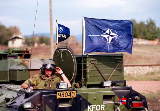 nato-flagget vaier over en norsk sisu i landsbyen plementina i kosovo sept 99the nato flag on a norwegian sisu in the village plementina in kosovo sept. 1999