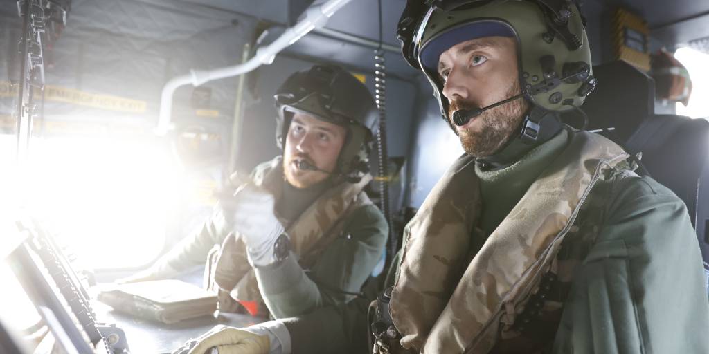 A Merlin Observer and Aircrewman from 814 NAS conduct the hunt for HMS Artful