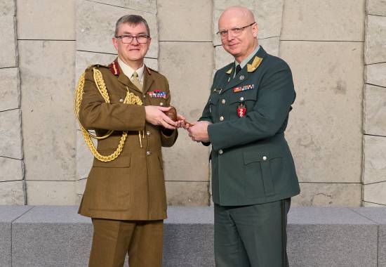 Major General Tim Hodgetts passing over the Chair of COMEDS position to Brigadier General Petter Iversen during the COMEDS 62nd Plenary Meeting